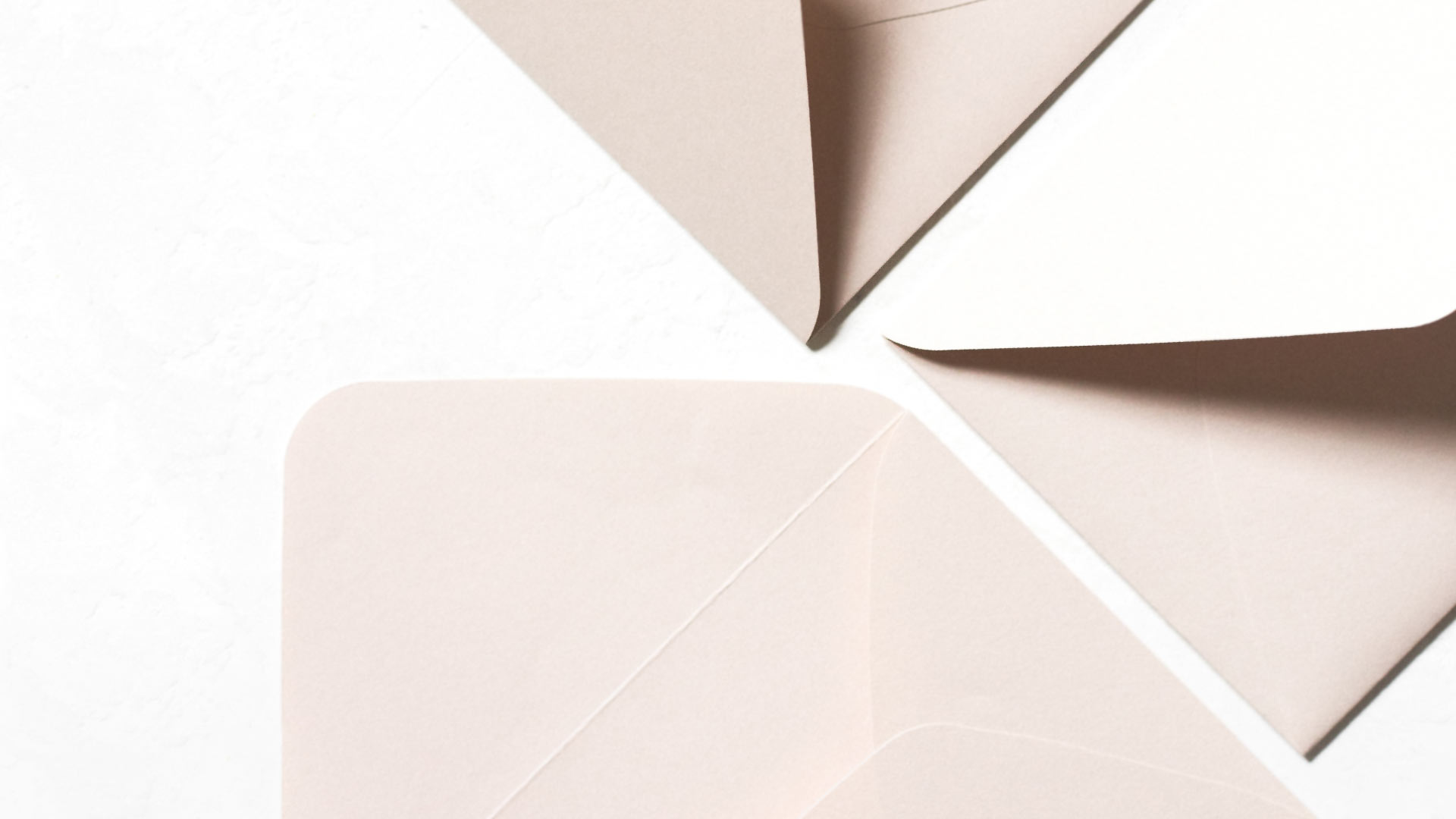 A composed image of paper envelopes arranged in a geometric pattern